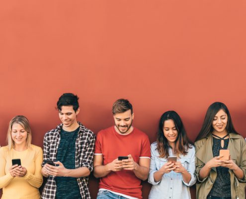 a line of gen z playing with their phones